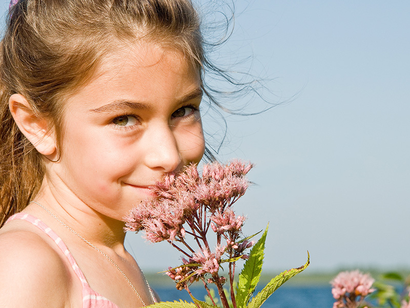 A child smelling flowers